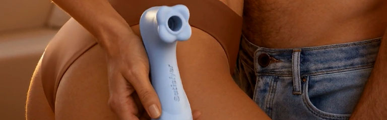 A woman cups the Pro 2 Gen 4 in her hand as she presses up against her partner