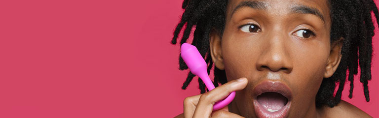 A man holds the beginner friendly Snug Plug 1 Butt Plug up to his face.