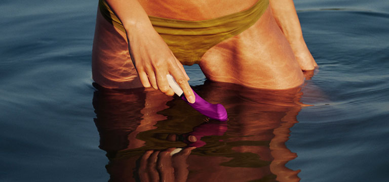 A bikini clad woman holds the Lelo Gigi 3 as the steps out of a pool. Non-realistic sex toys like the Gigi 3 are a great choice if you're looking to bring one on your holiday to Bali.